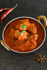 Spicy red chicken curry. Goan style chicken vindaloo. Butter chicken Murgh Makhani curry roast hot and spicy gravy dish Dhaba Punjab, India. North Indian non-vegetarian cuisine Garam Masala. tikka