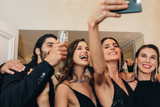 Socialites taking selfie at a party