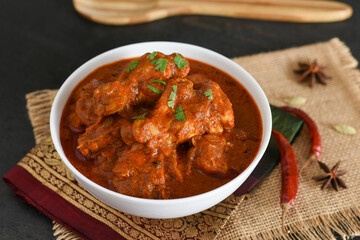 Spicy red chicken curry. Goan style chicken vindaloo. Butter chicken Murgh Makhani curry roast hot and spicy gravy dish Dhaba Punjab, India. North Indian non-vegetarian cuisine Garam Masala. tikka