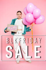 young woman holding carton box with favorite shoes and balloons while standing near blk friday sale lettering on pink