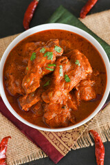 Spicy red chicken curry. Goan style chicken vindaloo. Butter chicken Murgh Makhani curry roast hot and spicy gravy dish Dhaba Punjab, India. North Indian non-vegetarian cuisine Garam Masala. tikka