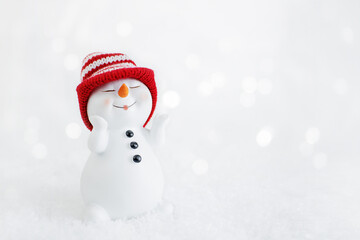 Happy snowman standing in winter christmas landscape. Merry christmas and happy new year greeting...