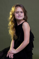 Dreamy little Princess. Cute little girl on dark Studio background.