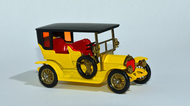 Toy diecast model of a Yellow  1907 Peugeot  a Matchbox yesteryear  product by Lesney with white background