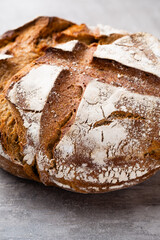 Gold rustic crusty loaves of bread and buns on wooden background. Still life captured from above top view, flat lay.