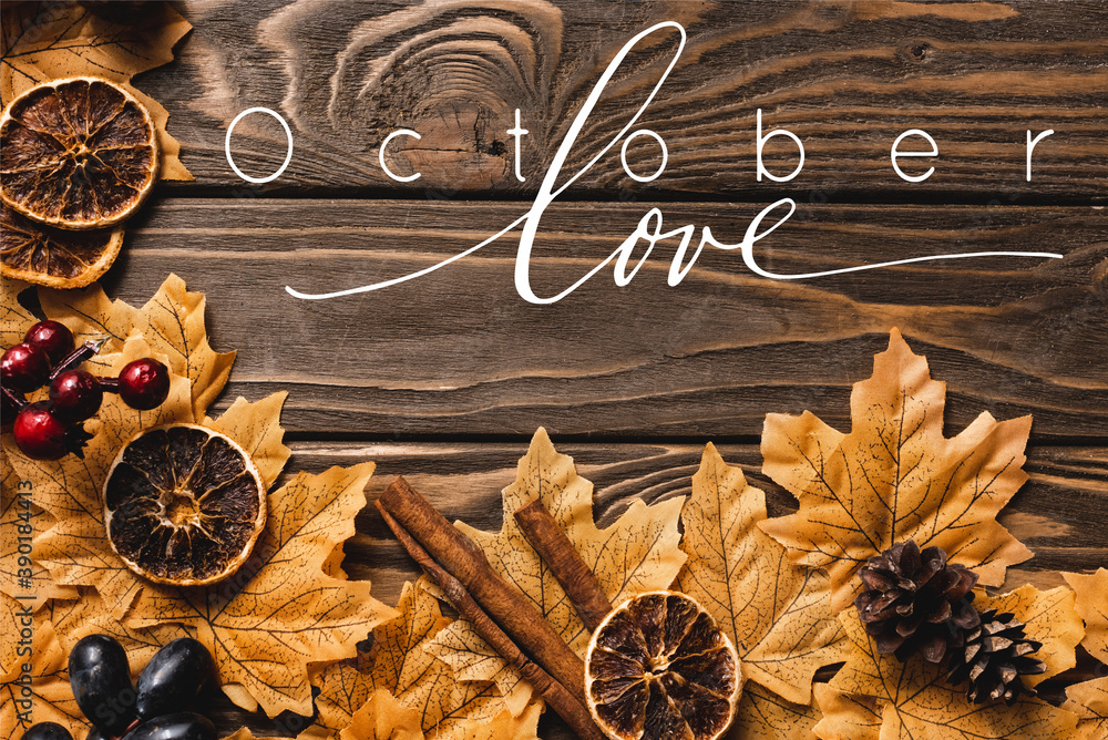 Wall mural Top view of autumnal decoration and foliage near October love lettering on wooden background - Wall murals