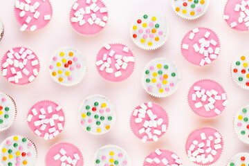 Colorful cupcakes on a white background.