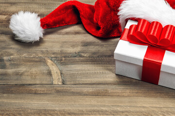Obraz na płótnie Canvas Christmas decorationand gift box red ribbon bow wooden background