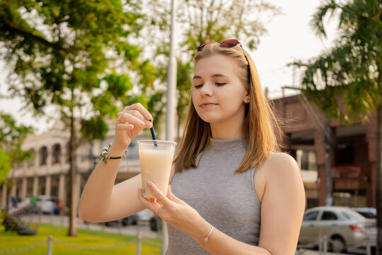 Young beautiful Brazilian female drinking Somo, a Bolivian drink