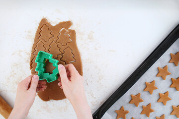 Making christmas gingerbread cookies. Cutting Christmas ginger cookies top view