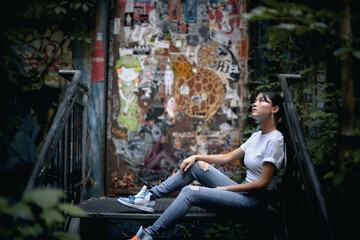 Thoughtful woman sitting on staircase