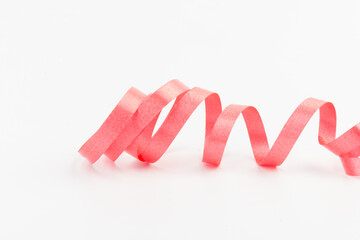 Top view of Red ribbon isolated shiny rolled on white background. Flat lay view.