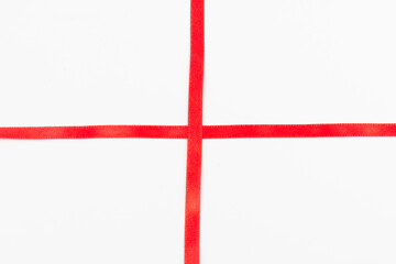 Obraz premium Top view of Red ribbon isolated shiny rolled on white background. Flat lay view.