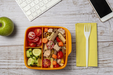 Lunch at workplace healthy pasta with tuna, tomatoes, in lunch box