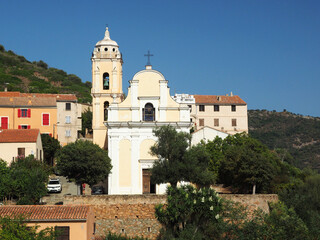 Fototapeta na wymiar Facade and tower of the Roman Catholic Church of the Assumption in Cargese