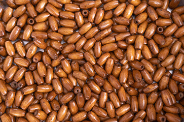 Top view of wooden beads background, closeup.
Selected focus.