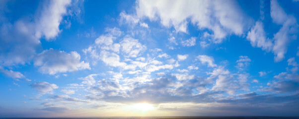 Naklejka na ściany i meble Panorama of bright evening and morning sky, shining sun.