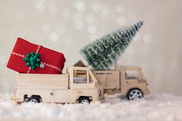 Christmas trucks with gift and christmas tree on snow