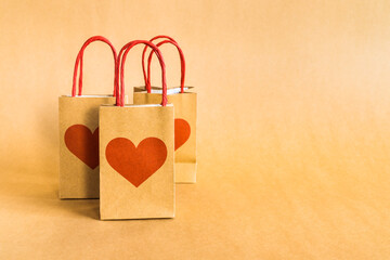Valentine's Day concept. Shopping paper bags with hearts print background. 