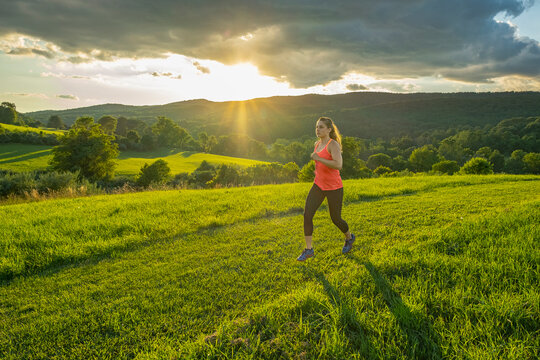 USA, Woman running in field