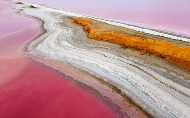 Aerial view of pink salt lakes, sandy and salt shores along the cape.