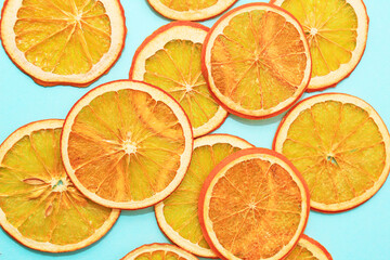 Fototapeta na wymiar Pattern of orange chips slices on blue background. Concept of healthl snack, diet