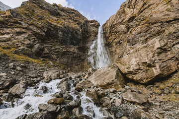 Fototapeta na wymiar Waterfall in mountain. Hiking and ecotourism in Caucasus mountain.