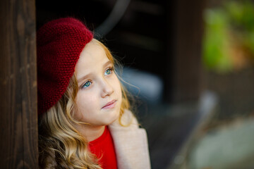 Cute girl in red beret on a walk in the fall