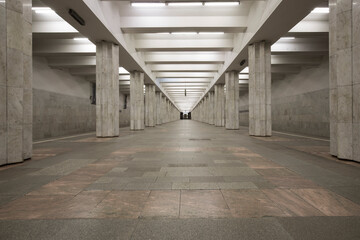 Linear perspective symmetrical view of an underground station with two rows of multiple columns. No...