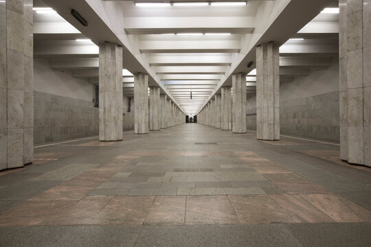 Linear Perspective Symmetrical View Of An Underground Station With Two Rows Of Multiple Columns. No People