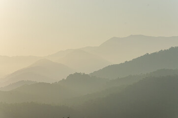 Scenic view of forest mountains with tropical foliage and a morning mist sky