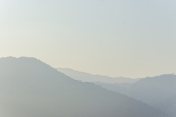 Scenic view of forest mountains with tropical foliage and a morning mist sky