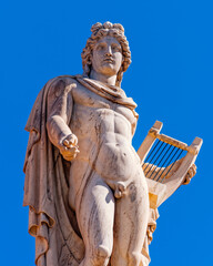 Athens Greece, Apollo ancient god of poetry and music marble statue on plain background