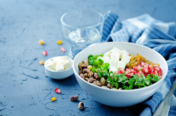 Barley pomegranate raisins feta salad in a bowl