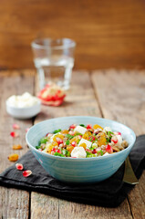Barley pomegranate raisins feta salad in a bowl