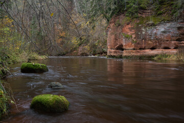 City Cesis, Latvia. Rapid river with stones and trees. Natural flora.Travel photo.