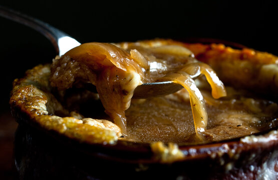 Close up of French onion soup with garlic gruyere croutons served in pot