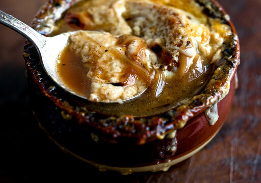 Close up of French onion soup with garlic gruyere croutons served in pot