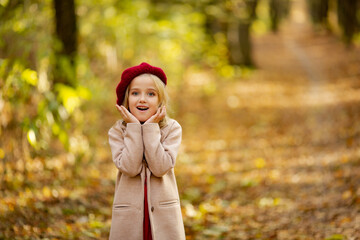 Cute girl in red beret on a walk in the fall