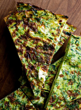 Close up of frittata with grated zucchini, goat cheese and dill