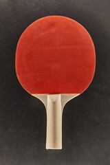 Pingpong racket on a dark surface