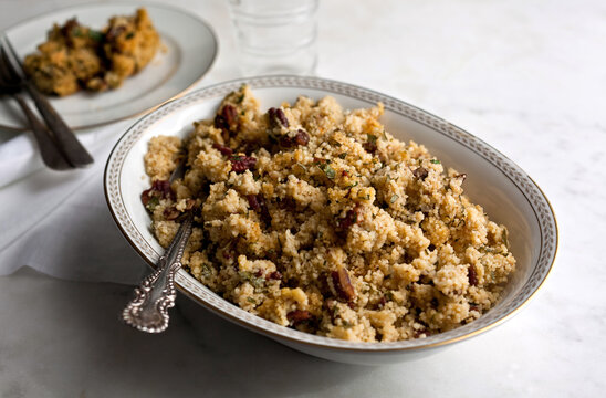 Close up of lemony couscous and pecan with parsley and garlic served in bowl