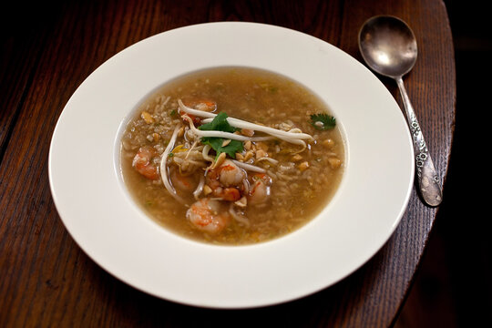 Close up of shrimp and brown rice soup on table