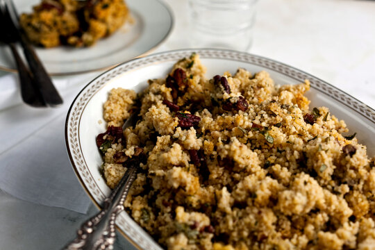 Close up of lemony couscous and pecan with parsley and garlic served in bowl