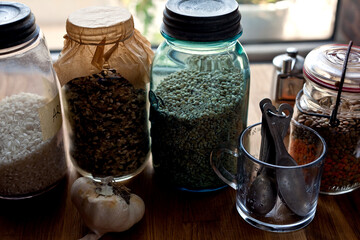 Variety of cereal grains in air tight containers on table