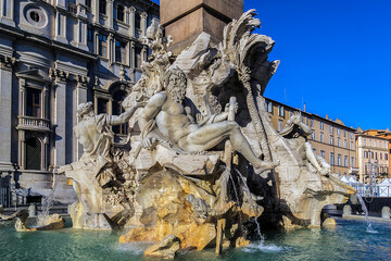 Fototapeta na wymiar Fountain of the Four Rivers (Fontana dei Quattro Fiumi, by Gian Lorenzo Bernini, 1651) with Egyptian obelisk, in the middle of Piazza Navona. Rome, Italy.