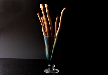 Close up of whole wheat and walnut breadsticks in glass