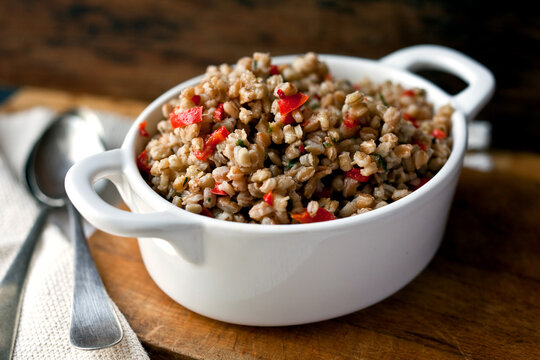 Close up of barley and farro risotto with red peppers served in bowl