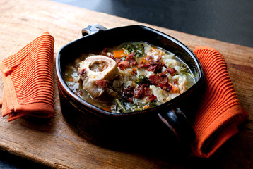Ham bone soup served in casserole on table
