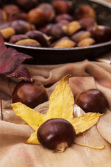 chestnuts in a pan on a wooden background
